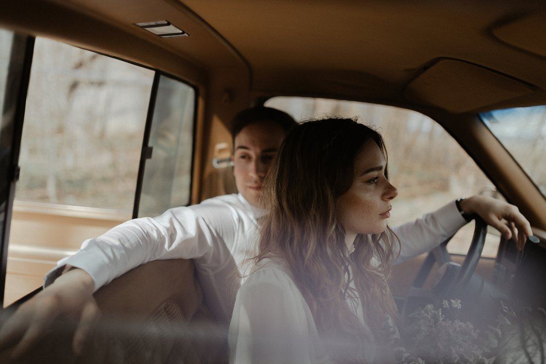 Kristina at the wheel of a vintage GMC pickup with her love beside her