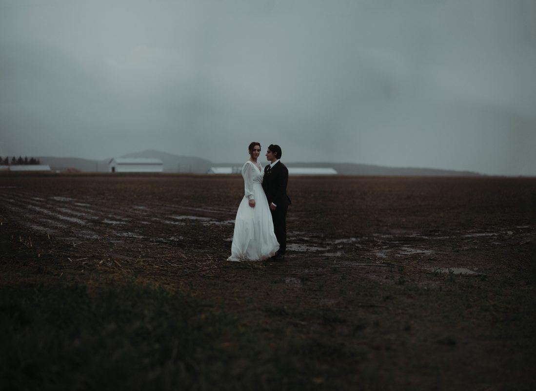 Catherine and Serina in a wide open field under a heavy sky