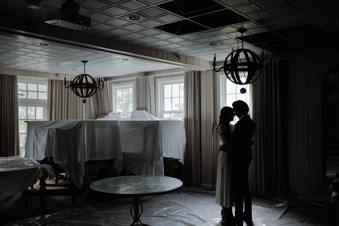 Katherine and Antoine in silhouette against the window light